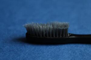 toothbrush on a blue background, side view. How to choose the right toothbrush photo