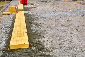 Road works. Laying pedestrian tiles with relief for the blind photo