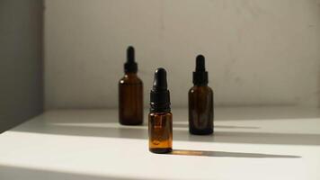 three bottles of essential oils sit on a table photo