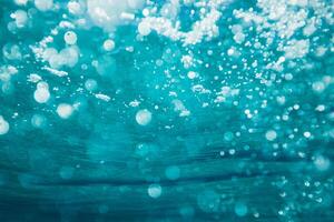 a close up view of bubbles in the ocean photo
