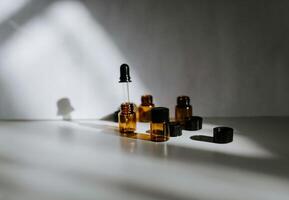 essential oils on a table with shadows photo