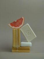 a soap bar with a grapefruit on top photo