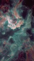 Colorful cosmic clouds swirl in a galactic formation captured in deep space video