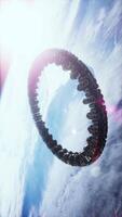 A futuristic spaceship hovers in orbit above Earth during a bright day in space video