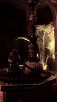 A room with candles and a table with a vase on it video