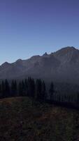 A view of a mountain range with trees and mountains in the background video