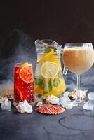 cocktails with ice and lemon slices on a dark background photo