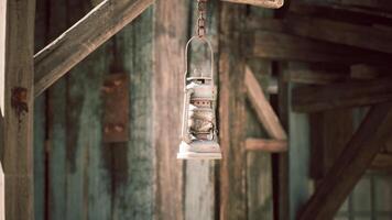 Vintage hanging lantern in rustic wooden setting at dusk video