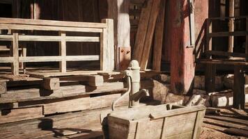 Rustic water pump near wooden structures in an old village setting video