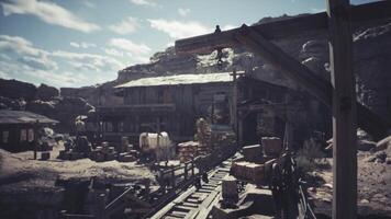 Abandoned mining town with wooden structures under a cloudy sky video