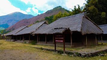 Discover aerial views of the traditional village at the foot of Mount Rinjani, showcasing a cool atmosphere, lush gardens, and beautiful hills surrounding the area. photo