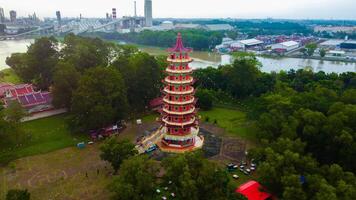 Enchanting sunset at Pulau Kemaro, Palembang. The pagoda and klenteng by the riverside offer a picturesque view, perfect for serene visuals. photo