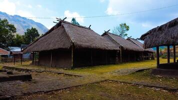 Discover aerial views of the traditional village at the foot of Mount Rinjani, showcasing a cool atmosphere, lush gardens, and beautiful hills surrounding the area. photo
