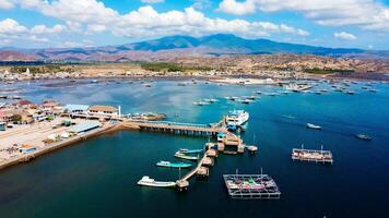 Aerial views of the harbor leading to Labuan Bajo, featuring deep blue waters and a clear sky, with boats ready to sail towards the Labuan Bajo, Indonesia photo
