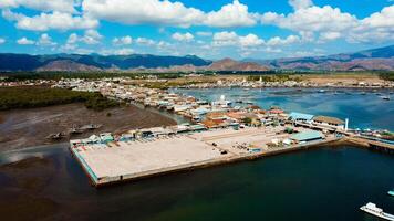 Aerial views of the harbor leading to Labuan Bajo, featuring deep blue waters and a clear sky, with boats ready to sail towards the Labuan Bajo, Indonesia photo