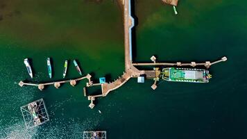 Aerial views of the harbor leading to Labuan Bajo, featuring deep blue waters and a clear sky, with boats ready to sail towards the Labuan Bajo, Indonesia photo