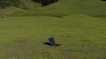 Laptop outside concept. Empty copy space, blank screen mockup. Soft focus laptop in nature background. Ecology travel and work outside office concept. photo