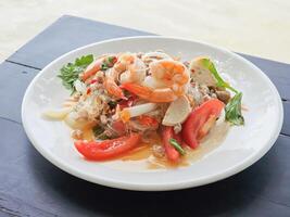 Spicy Glass Noodle Salad, mixed shrimp with minced pork, Thai call Yum Woon Sen on the table. Side view photo