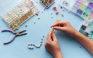 Creating colorful beaded jewelry with vibrant materials on a crafting table photo