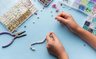 Creating colorful beaded jewelry with vibrant materials on a crafting table photo