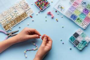 Creating colorful beaded jewelry with vibrant materials on a crafting table photo
