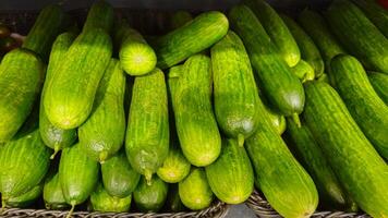 Cucumbers background. Cucumbers on store shelves. Vegetables in the store photo