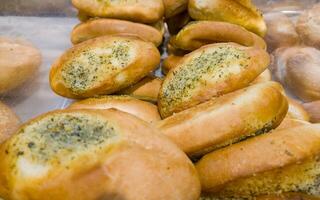 Buns with cheese and dill on the counter in the store. Bakery products on sale photo