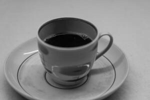 Instant coffee in a mug. A mug in a saucer on a yellow background. Top-down view photo