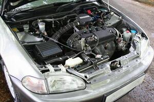 view of a car with its hood open, showcasing the engine and various mechanical parts. Ideal for automotive and mechanical themes, depicting technology, repair, and engineering concepts. photo