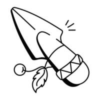 A doodle icon of a stone knife with a feather and bead vector