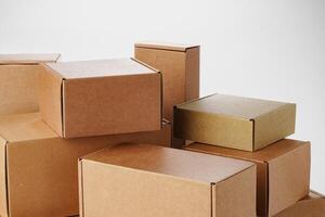 Stacked brown cardboard boxes in various sizes arranged on a white background photo