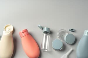 Collection of various reusable cosmetic containers arranged on a light gray background photo