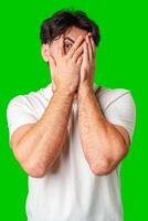 Surprised young man with a beard expressing shock against a bright green background photo