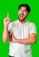 Man with a beard smiling and raising finger in a bright green studio photo