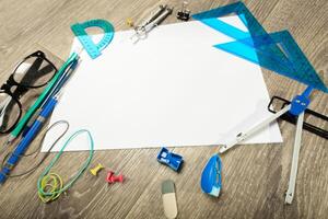 Blank notebook and pencil with glasses on wooden table photo
