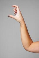 signaling a small size against a gray background photo