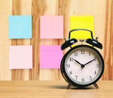 Alarm clock with blank or empty adhesive note photo