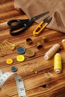 Crafting tools and materials arranged on a wooden table ready for sewing and creative projects photo