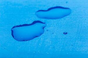 water drop on surface of fresh blue background photo