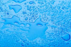 water drop on surface of fresh blue background photo