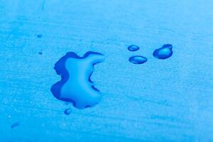 water drop on surface of fresh blue background photo