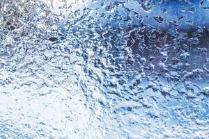 Frozen ice pattern on glass photo