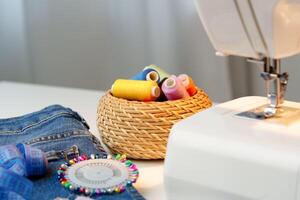 Sewing machine in use on a wooden table, stitching a light fabric in a well-lit indoor workspace photo