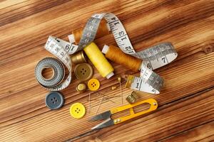 Crafting tools and materials arranged on a wooden table for sewing projects photo