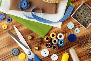 Crafting tools and materials arranged on a wooden table for sewing projects photo