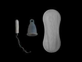Various menstrual products - pads, tampon and menstrual cup isolated on black background. Concept of choice and comparison with copy space photo