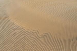 Sand textured pattern with copy space. Abstract background wallpaper. Sand waves in a desert dune photo