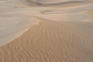 Sand textured pattern with copy space. Abstract background wallpaper. Sand waves in a desert dune photo