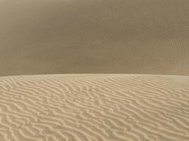 Sand textured pattern with copy space. Abstract background wallpaper. Sand waves in a desert dune photo