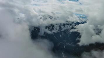 Aerial view of snowcapped mountains in clouds photo